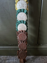 Load image into Gallery viewer, Vintage pig whip with rosettes 1960's red, blue, brown