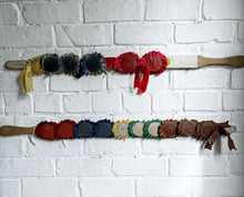 Load image into Gallery viewer, Vintage pig whip with rosettes 1960's red, blue, brown