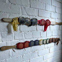 Load image into Gallery viewer, Vintage pig whip with rosettes 1960's red, blue, brown