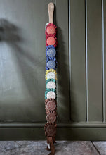 Load image into Gallery viewer, Vintage pig whip with rosettes 1960's red, blue, brown