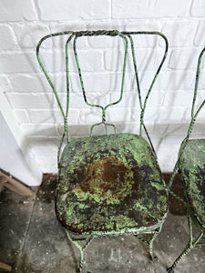 A pair of 1940's vintage French metal twisted wire green garden bistro chairs