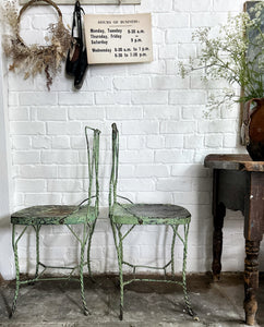 A pair of 1940's vintage French metal twisted wire green garden bistro chairs