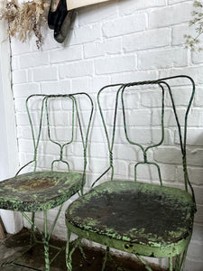 A pair of 1940's vintage French metal twisted wire green garden bistro chairs