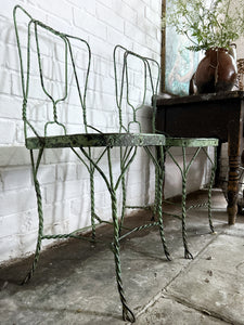 A pair of 1940's vintage French metal twisted wire green garden bistro chairs