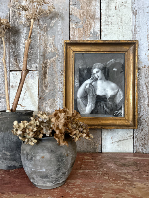 A framed antique print of an engraving of Laura Dianti from the original painted by Titian