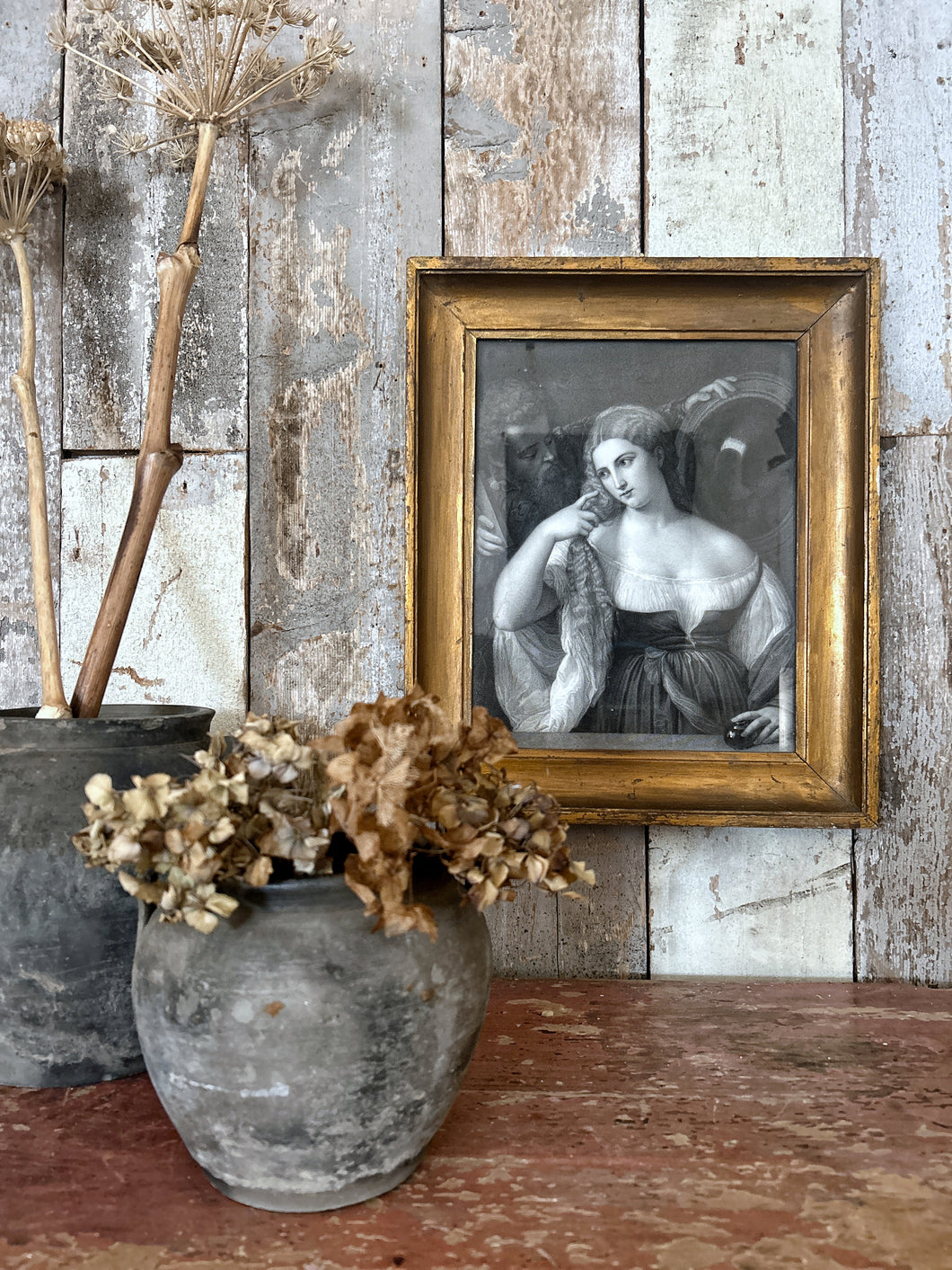 A framed antique print of an engraving of Laura Dianti from the original painted by Titian
