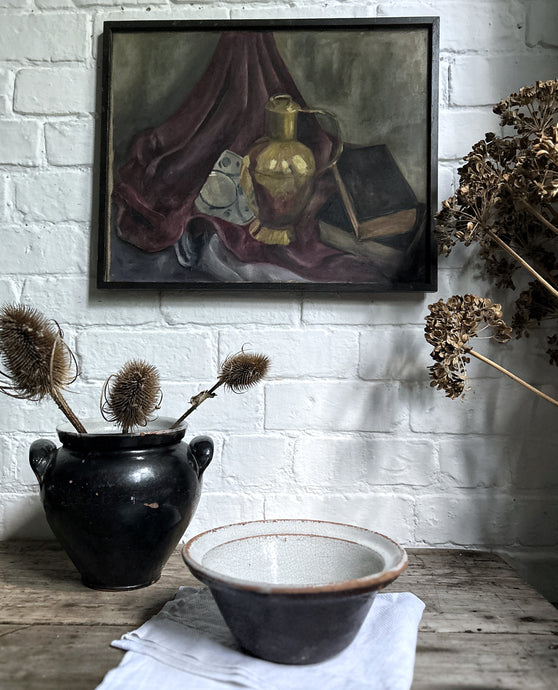 A vintage black glazed French Farmhouse style mixing bowl