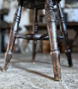 An antique Victorian Windsor dark wooden stool