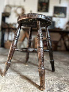An antique Victorian Windsor dark wooden stool