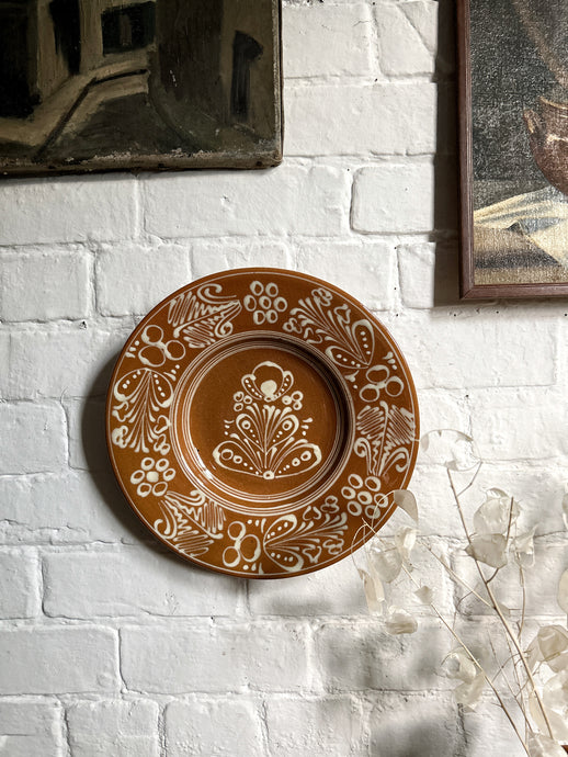 A decorative Hungarian hand painted glazed plate