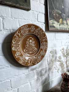 A decorative Hungarian hand painted glazed plate