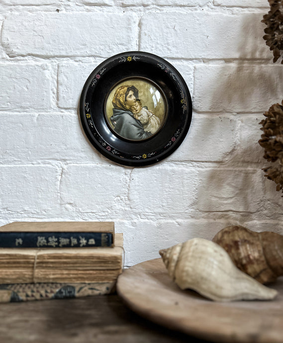A Vintage folk art hand painted round circular black frame with vintage print