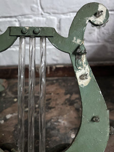 A pair of French metal lyre shaped candle wall sconces with glass flower decoration