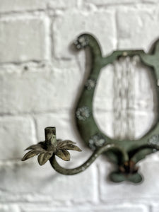 A pair of French metal lyre shaped candle wall sconces with glass flower decoration