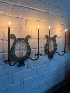 A pair of French metal lyre shaped candle wall sconces with glass flower decoration