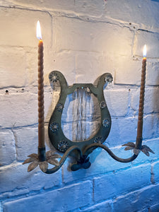 A pair of French metal lyre shaped candle wall sconces with glass flower decoration
