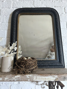 A French antique Louis Philippe black and gold mirror