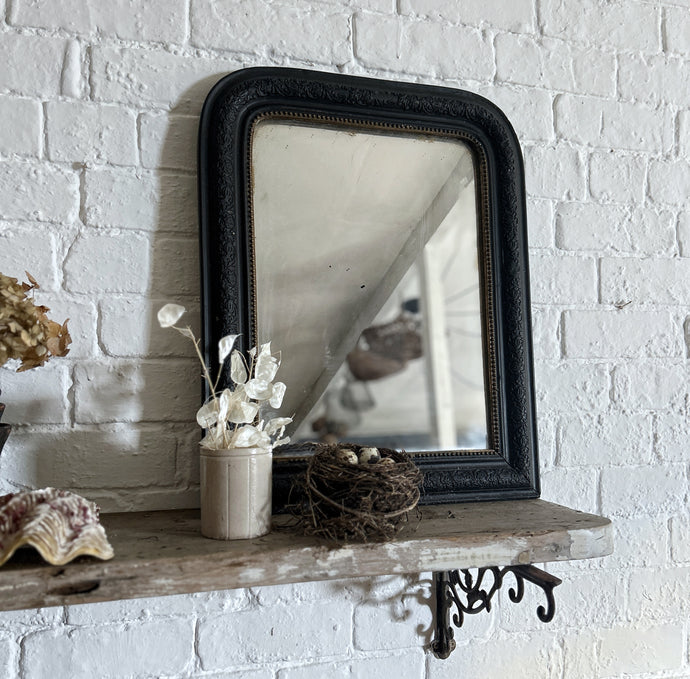 A French antique Louis Philippe black and gold mirror