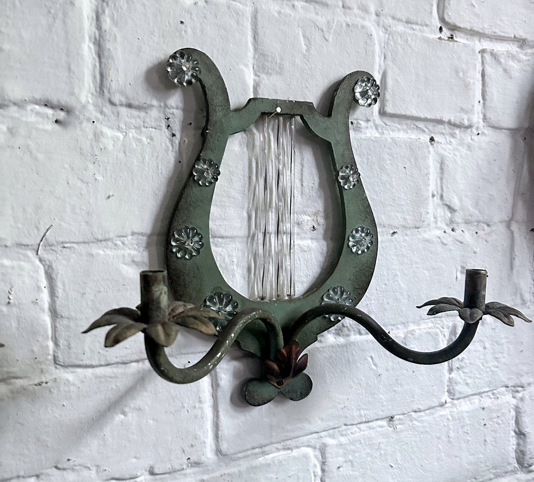A pair of French metal lyre shaped candle wall sconces with glass flower decoration