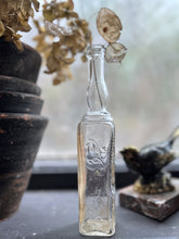 Load image into Gallery viewer, A small French vintage glass liquor bottle with original label manufactured in Paris