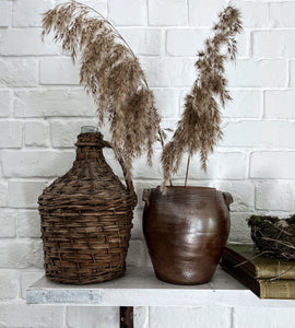 A 20th Century Vintage french wicker covered demijohn wine bottle