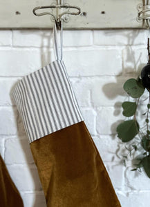 velvet ochre, hazel, brown,umber, christmas stocking with a contrasting black & white ticking striped top