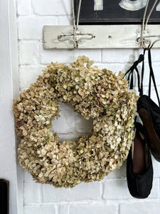 A hand made dried pale green hydrangea floral wreath