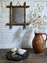 Load image into Gallery viewer, An antique Oxford cross faux bamboo wall mirror with distressed foxed glass plate
