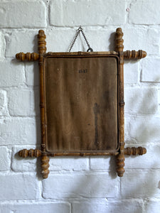 An antique Oxford cross faux bamboo wall mirror with distressed foxed glass plate