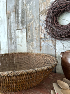 An antique rustic woven wicker Japanese tea basket