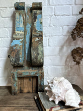 Load image into Gallery viewer, A large wooden scroll shaped bracket with original blue chippy paint