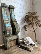 Load image into Gallery viewer, A large wooden scroll shaped bracket with original blue chippy paint