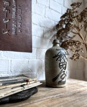Load image into Gallery viewer, A vintage Japanese clay pottery saki bottle with calligraphy front &amp; back