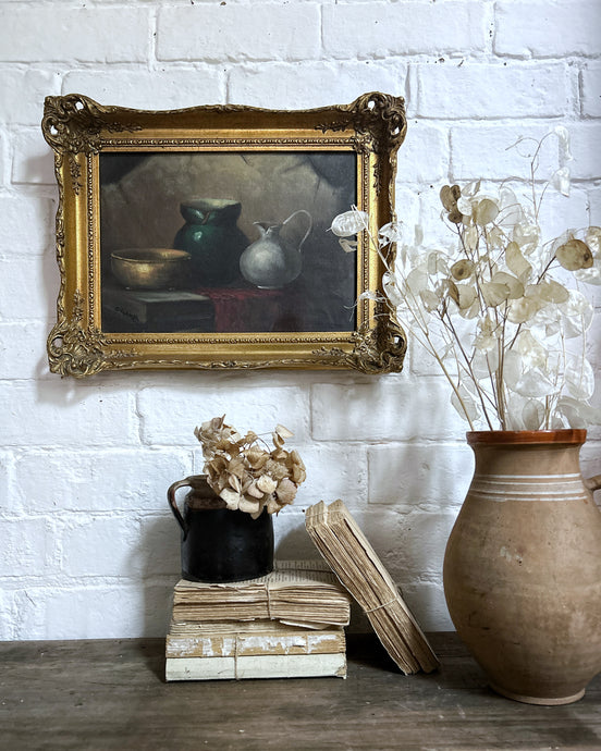 A vintage still life oil painting on board in gilt frame signed