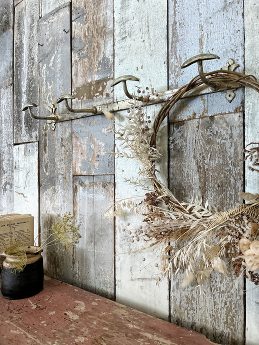 A French vintage metal cream painted coat rack with 4 knobs