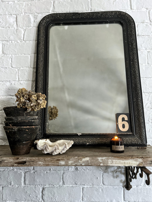 A vintage French black Louis Philippe over mantle mirror