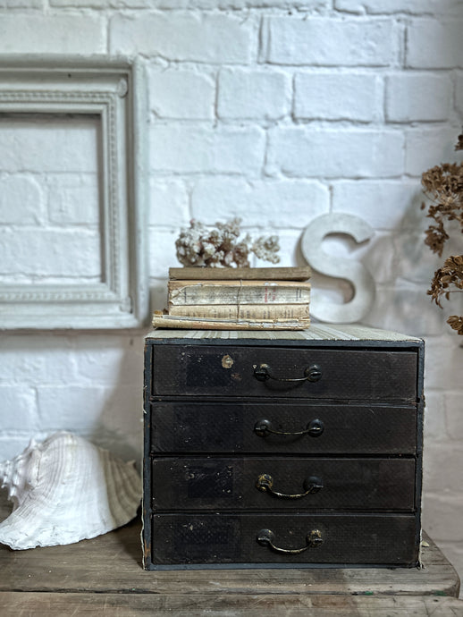 A set of vintage desk top stationary drawers covered in striped ticking fabric