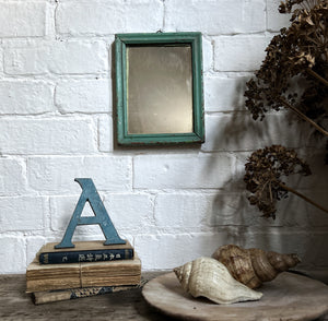 A small antique wooden blue painted wall hung mirror