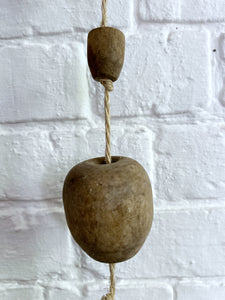 A string of reclaimed French vintage hanging wooden balls on rope