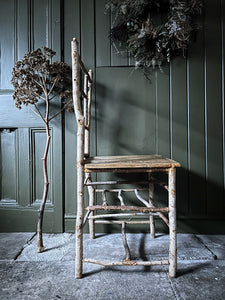 Primitive coppiced wood twig chair with carved mouse on back