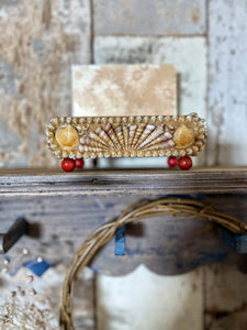 A Vintage art deco style shell covered jewellery box with red ball feet