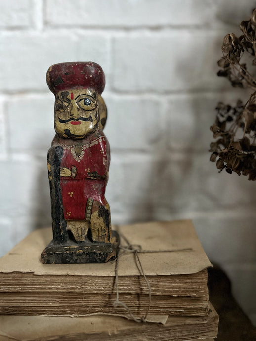 A decorative vintage Indian wooden carved hand painted folk art watchman figure.