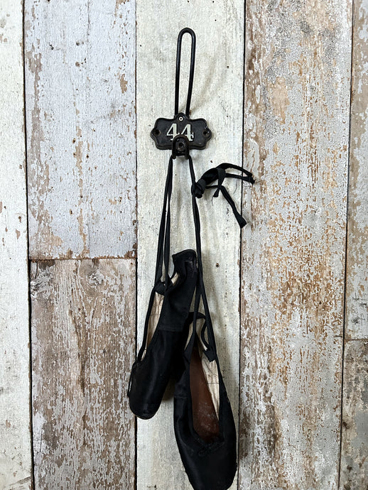 Vintage industrial cast iron numbered shield back coat hook number 44.