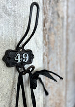 Load image into Gallery viewer, A Vintage industrial cast iron numbered shield back coat hook number 49.