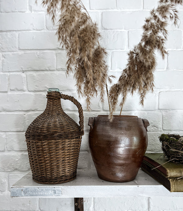 A 20th Century Vintage french wicker covered demijohn wine bottle