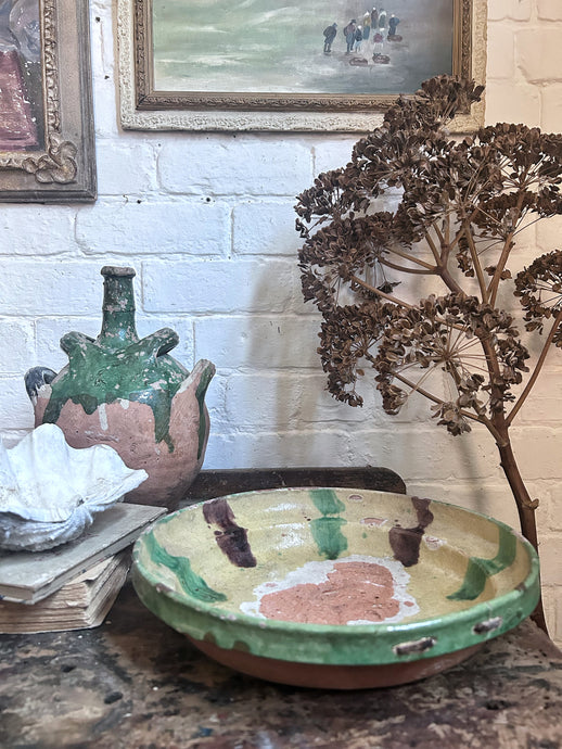An antique 19th century, Whieldon type dish, bowl with historic staple repairs