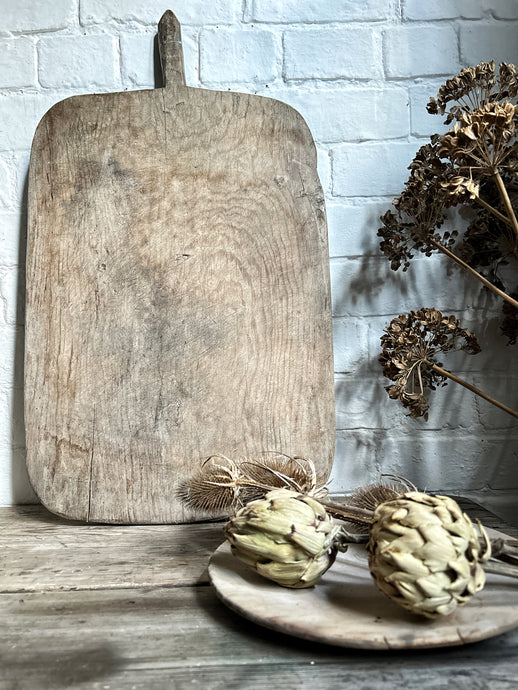 An Antique rustic hand carved wooden bread board