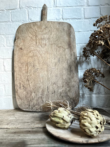 An Antique rustic hand carved wooden bread board