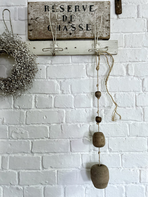 A string of reclaimed French vintage hanging wooden balls on rope