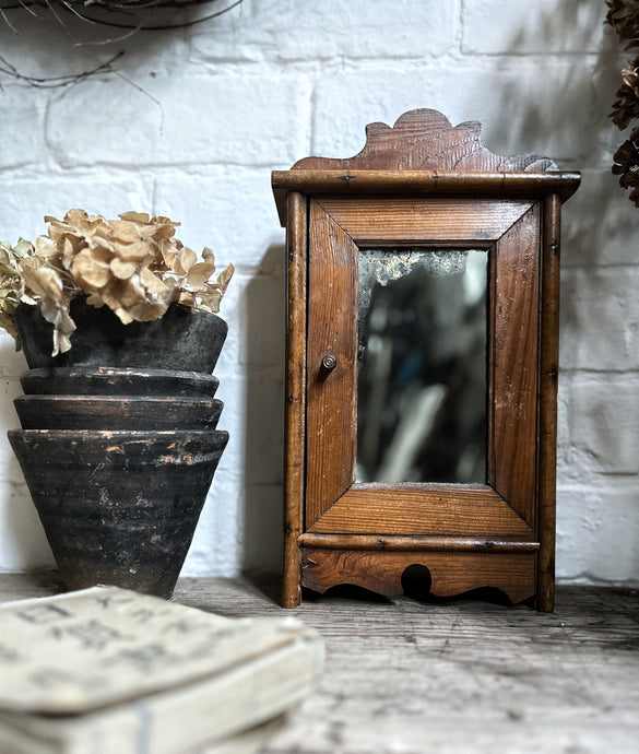 Small French antique wall hung wooden cabinet with shelves foxed glass door mirror